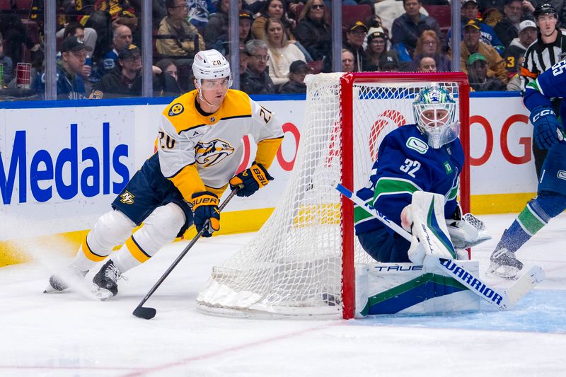 Jan 3, 2025; Vancouver, British Columbia, CAN; Vancouver Canucks goalie Kevin Lankinen (32) watches as Nashville Predators defenseman Justin Barron (20) handles the puck in the third period at Rogers Arena. Mandatory Credit: Bob Frid-Imagn Images