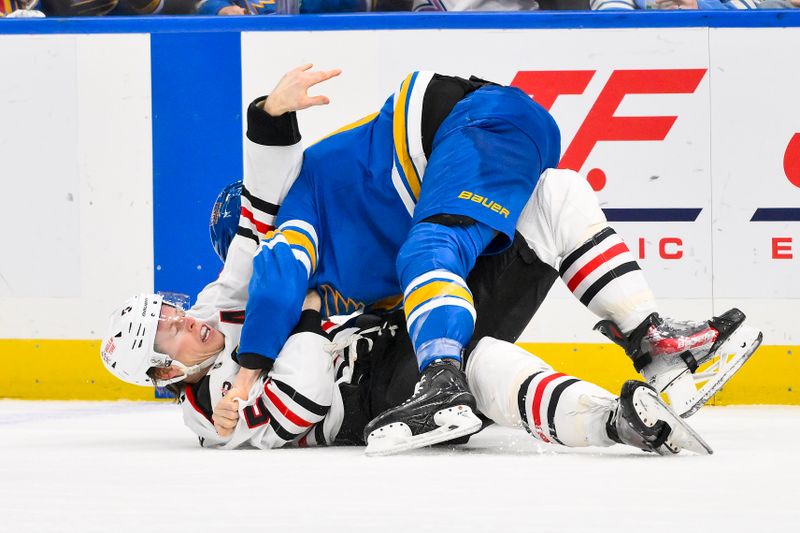 Dec 12, 2025; St. Louis, Missouri, USA; St. Louis Blues left wing Dylan Holloway (81) fights Chicago Blackhawks defenseman Connor Murphy (5) during the second period  at Enterprise Center. Mandatory Credit: Jeff Curry-Imagn Images