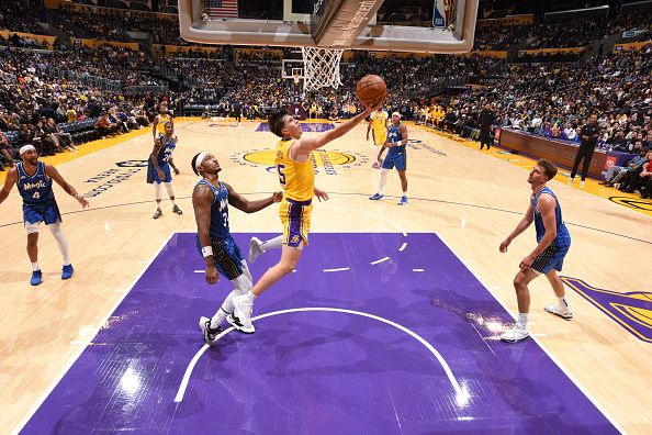 LOS ANGELES, CA - OCTOBER 30: Austin Reaves #15 of the Los Angeles Lakers drives to the basket during the game against the Orlando Magic on October 30, 2023 at Crypto.Com Arena in Los Angeles, California. NOTE TO USER: User expressly acknowledges and agrees that, by downloading and/or using this Photograph, user is consenting to the terms and conditions of the Getty Images License Agreement. Mandatory Copyright Notice: Copyright 2023 NBAE (Photo by Adam Pantozzi/NBAE via Getty Images)