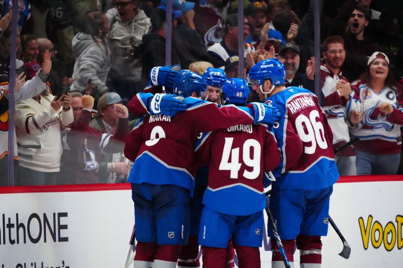 Oct 18, 2024; Denver, Colorado, USA; Colorado Avalanche center Ross Colton (20) and center Nathan MacKinnon (29) and defenseman Cale Makar (8) and right wing Mikko Rantanen (96) celebrate a third period goal against the Anaheim Ducks at Ball Arena. Mandatory Credit: Ron Chenoy-Imagn Images