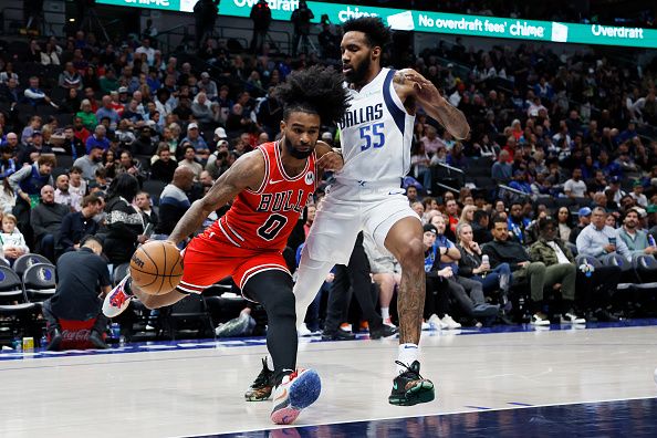 DALLAS, TEXAS - NOVEMBER 01: Coby White #0 of the Chicago Bulls drives to the basket against Derrick Jones Jr. #55 of the Dallas Mavericks in the second half at American Airlines Center on November 01, 2023 in Dallas, Texas. NOTE TO USER: User expressly acknowledges and agrees that, by downloading and or using this photograph, User is consenting to the terms and conditions of the Getty Images License Agreement. (Photo by Tim Heitman/Getty Images)