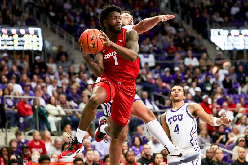 Jan 13, 2024; Fort Worth, Texas, USA; Houston Cougars guard Jamal Shead (1) passes past TCU Horned Frogs forward JaKobe Coles (21) during the second half at Ed and Rae Schollmaier Arena. Mandatory Credit: Kevin Jairaj-USA TODAY Sports