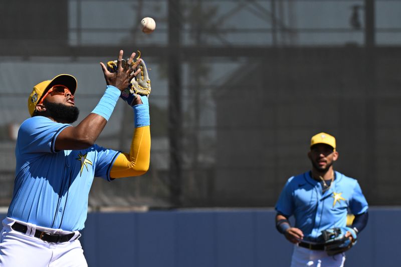 Feb 24, 2024; Port Charlotte, Florida, USA; Tampa Bay Rays third baseman Junior Caminero (13) catches a fly ball in the second inning of a spring training game against the Atlanta Braves at Charlotte Sports Park. Mandatory Credit: Jonathan Dyer-USA TODAY Sports