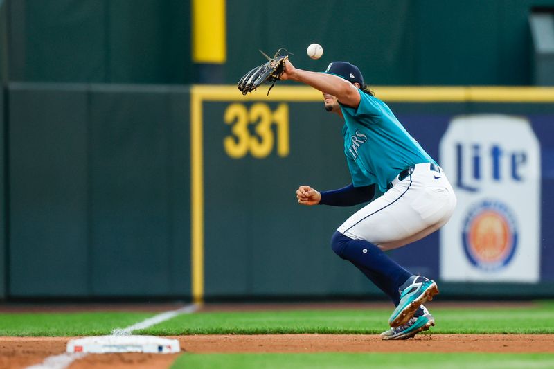 Aug 3, 2024; Seattle, Washington, USA; Seattle Mariners third baseman Josh Rojas (4) bobbles a grounder against the Philadelphia Phillies during the fifth inning at T-Mobile Park. Mandatory Credit: Joe Nicholson-USA TODAY Sports