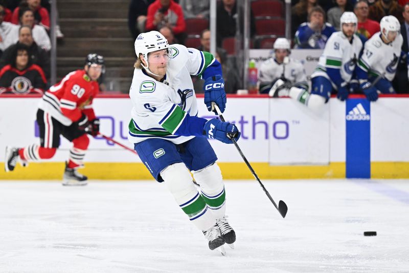 Feb 13, 2024; Chicago, Illinois, USA; Vancouver Canucks forward Brock Boeser (6) passes the puck up ice in the first period against the Chicago Blackhawks at United Center. Mandatory Credit: Jamie Sabau-USA TODAY Sports