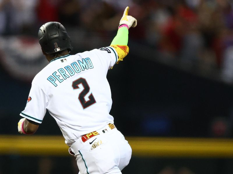 Oct 11, 2023; Phoenix, Arizona, USA; Arizona Diamondbacks shortstop Geraldo Perdomo (2) reacts after hitting a home run against the Los Angeles Dodgers in the third inning for game three of the NLDS for the 2023 MLB playoffs at Chase Field. Mandatory Credit: Mark J. Rebilas-USA TODAY Sports