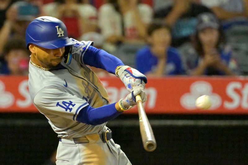Sep 3, 2024; Anaheim, California, USA;  Los Angeles Dodgers shortstop Mookie Betts (50) hits a three-run home run in the tenth inning against the Los Angeles Angels at Angel Stadium. Mandatory Credit: Jayne Kamin-Oncea-Imagn Images