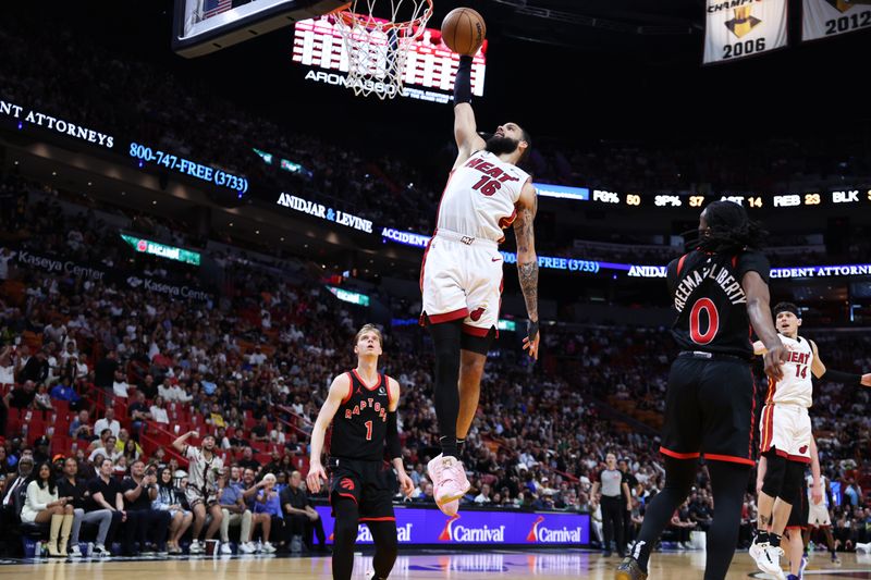 MIAMI, FLORIDA - APRIL 14: Caleb Martin #16 of the Miami Heat dunks the ball against the Toronto Raptors during the second quarter of the game at Kaseya Center on April 14, 2024 in Miami, Florida. NOTE TO USER: User expressly acknowledges and agrees that, by downloading and or using this photograph, User is consenting to the terms and conditions of the Getty Images License Agreement. (Photo by Megan Briggs/Getty Images)