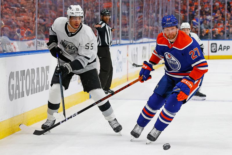 Apr 22, 2024; Edmonton, Alberta, CAN; Los Angeles Kings forward Quinton Byfield (55) and Edmonton Oilers defensemen Brett Kulak (27) chase a loose puck during the second period in game one of the first round of the 2024 Stanley Cup Playoffs at Rogers Place. Mandatory Credit: Perry Nelson-USA TODAY Sports