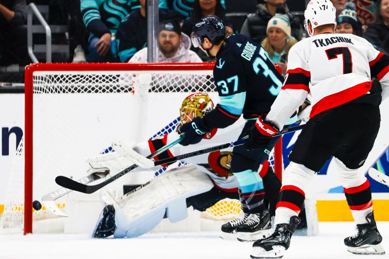 Jan 4, 2024; Seattle, Washington, USA; Seattle Kraken center Yanni Gourde (37) scores a goal against Ottawa Senators goaltender Joonas Korpisalo (70) during the first period at Climate Pledge Arena. Mandatory Credit: Joe Nicholson-USA TODAY Sports