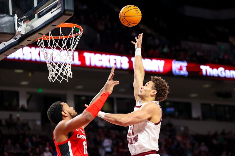 Mar 4, 2023; Columbia, South Carolina, USA; South Carolina Gamecocks forward Benjamin Bosmans-Verdonk (31) shoots over Georgia Bulldogs forward Jailyn Ingram (15) in the first half at Colonial Life Arena. Mandatory Credit: Jeff Blake-USA TODAY Sports