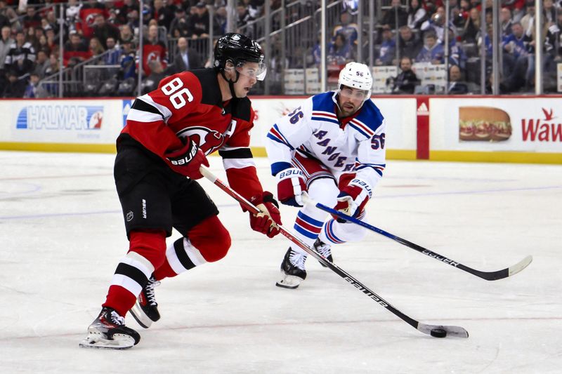 Nov 18, 2023; Newark, New Jersey, USA; New Jersey Devils center Jack Hughes (86) skates with the puck against New York Rangers defenseman Erik Gustafsson (56) during the second period at Prudential Center. Mandatory Credit: John Jones-USA TODAY Sports