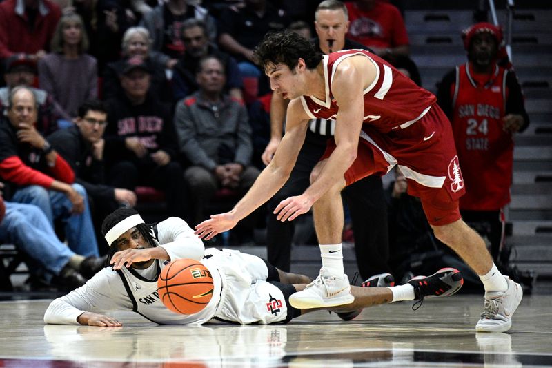 Dec 21, 2023; San Diego, California, USA; San Diego State Aztecs guard Reese Waters (14) and Stanford Cardinal guard Benny Gealer (15) battle for a loose ball during the second half at Viejas Arena. Mandatory Credit: Orlando Ramirez-USA TODAY Sports