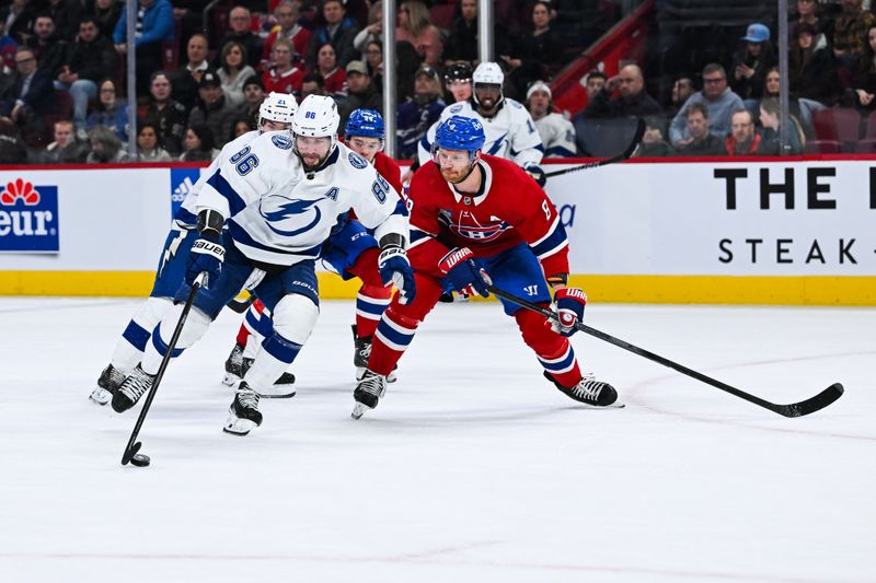 Apr 4, 2024; Montreal, Quebec, CAN; Tampa Bay Lightning right wing Nikita Kucherov (86) plays the puck against Montreal Canadiens defenseman Mike Matheson (8) during the second period at Bell Centre. Mandatory Credit: David Kirouac-USA TODAY Sports