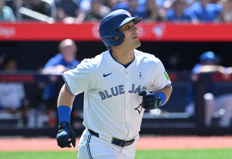 Jun 16, 2024; Toronto, Ontario, CAN;  Toronto Blue Jays center fielder Daulton Varsho (25) watches the flight of his grand slam home run against the Cleveland Guardians in the fifth inning at Rogers Centre. Mandatory Credit: Dan Hamilton-USA TODAY Sports