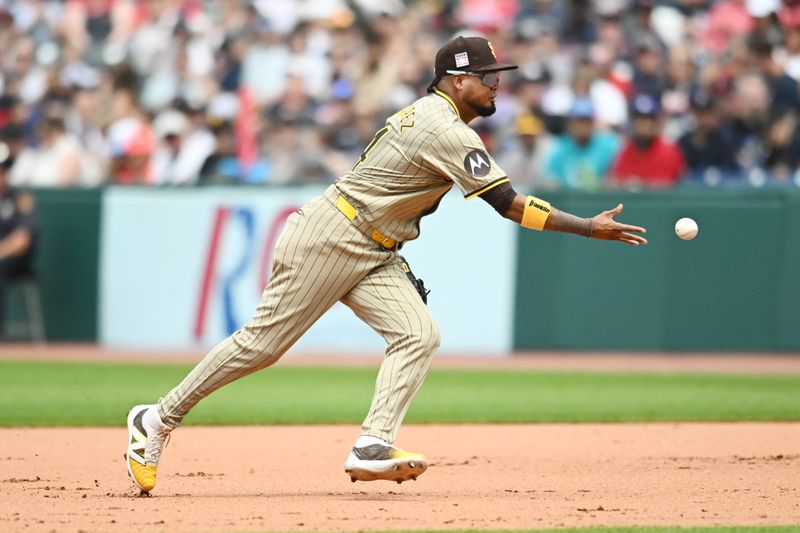 Jul 21, 2024; Cleveland, Ohio, USA; San Diego Padres first baseman Luis Arraez (4) flips to first to force out Cleveland Guardians second baseman Andres Gimenez (not pictured) during the fifth inning at Progressive Field. Mandatory Credit: Ken Blaze-USA TODAY Sports