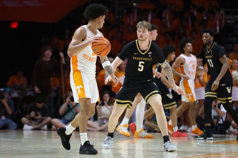 Mar 7, 2026; Knoxville, Tennessee, USA;  Tennessee Volunteers guard Bishop Boswell (3) is defended by Vanderbilt Commodores forward Tyler Nickel (5) during the second half at Thompson-Boling Arena at Food City Center. Mandatory Credit: Randy Sartin-Imagn Images