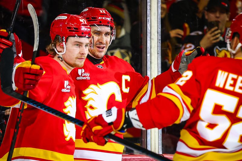 Dec 20, 2025; Calgary, Alberta, CAN; Calgary Flames center Mikael Backlund (11) celebrates his goal with teammates against the Vegas Golden Knights during the second period at Scotiabank Saddledome. Mandatory Credit: Sergei Belski-Imagn Images