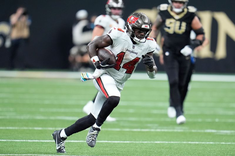 Tampa Bay Buccaneers wide receiver Chris Godwin (14) runs against the New Orleans Saints during the first half of an NFL football game in New Orleans, Sunday, Oct. 13, 2024. (AP Photo/Michael Conroy)