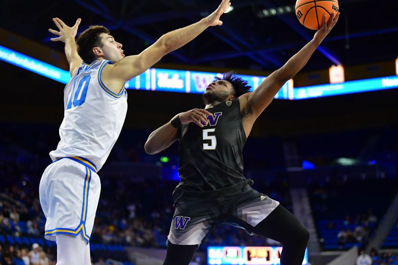 January 14, 2024; Los Angeles, California, USA; Washington Huskies guard Sahvir Wheeler (5) moves to the basket against UCLA Bruins guard Lazar Stefanovic (10) during the first half at Pauley Pavilion. Mandatory Credit: Gary A. Vasquez-USA TODAY Sports