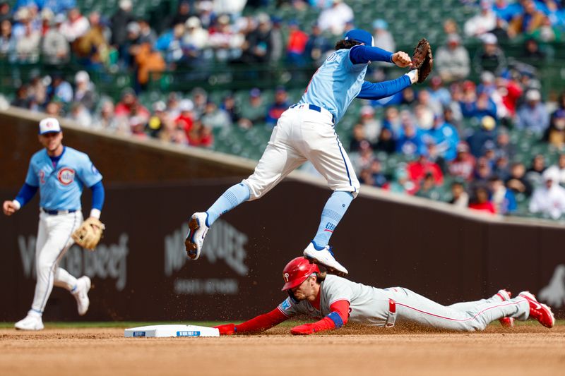 Apr 25, 2025; Chicago, Illinois, USA; Philadelphia Phillies second baseman Bryson Stott (5) steals second base against Chicago Cubs shortstop Dansby Swanson (7) during the first inning at Wrigley Field. Mandatory Credit: Kamil Krzaczynski-Imagn Images