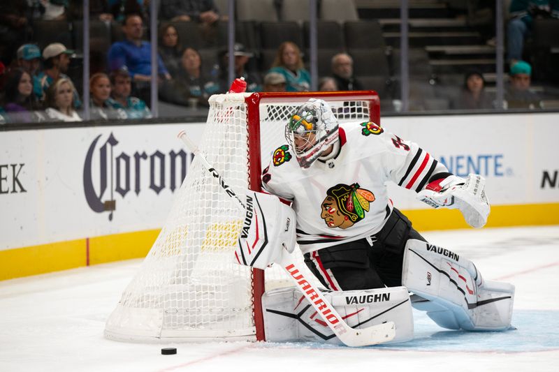 Oct 31, 2024; San Jose, California, USA; Chicago Blackhawks goaltender Petr Mrazek (34) deflects a San Jose Sharks shot on goal during the second period at SAP Center at San Jose. Mandatory Credit: D. Ross Cameron-Imagn Images