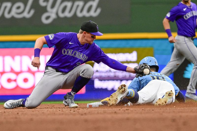 Sep 6, 2024; Milwaukee, Wisconsin, USA; Milwaukee Brewers center fielder Blake Perkins (16) steals second base before tag by Colorado Rockies second baseman Aaron Schunk (30) in the seventh inning at American Family Field. Mandatory Credit: Benny Sieu-Imagn Images