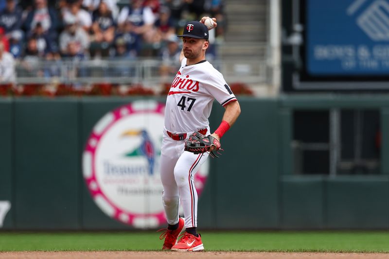 May 16, 2024; Minneapolis, Minnesota, USA; Minnesota Twins second baseman Edouard Julien (47) throws the ball to first base to get out New York Yankees Jon Berti (19) during the fourth inning at Target Field. Mandatory Credit: Matt Krohn-USA TODAY Sports