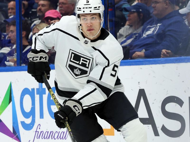 Jan 9, 2024; Tampa, Florida, USA; Los Angeles Kings defenseman Andreas Englund (5) passes the puck against the Tampa Bay Lightning during the first period at Amalie Arena. Mandatory Credit: Kim Klement Neitzel-USA TODAY Sports