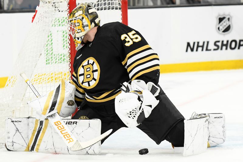 Feb 8, 2024; Boston, Massachusetts, USA; Boston Bruins goaltender Linus Ullmark (35) looks behind him for the puck during the second period against the Vancouver Canucks at TD Garden. Mandatory Credit: Bob DeChiara-USA TODAY Sports