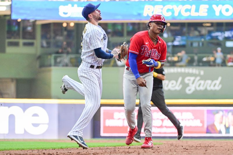 Sep 3, 2023; Milwaukee, Wisconsin, USA; Milwaukee Brewers second baseman Brice Turang (2) tags out Philadelphia Phillies center fielder Cristian Pache (19) after he was picked off first base in the third inning at American Family Field. Mandatory Credit: Benny Sieu-USA TODAY Sports