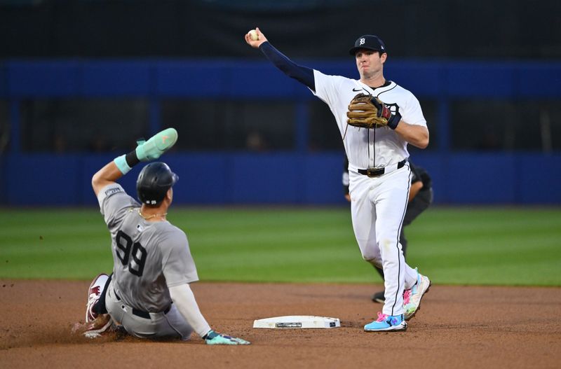 Aug 18, 2024; Williamsport, Pennsylvania, USA; Detroit Tigers infielder Colt Keith (33) turns a double play over New York Yankees outfielder Aaron Judge (99) in the fourth inning at BB&T Ballpark at Historic Bowman Field. Mandatory Credit: Kyle Ross-USA TODAY Sports