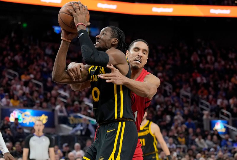 SAN FRANCISCO, CALIFORNIA - DECEMBER 23: Jonathan Kuminga #00 of the Golden State Warriors going in for a layup gets grabbed and fouled by Malcolm Brogdon #11 of the Portland Trail Blazers during the second half at Chase Center on December 23, 2023 in San Francisco, California. NOTE TO USER: User expressly acknowledges and agrees that, by downloading and or using this photograph, User is consenting to the terms and conditions of the Getty Images License Agreement. (Photo by Thearon W. Henderson/Getty Images)