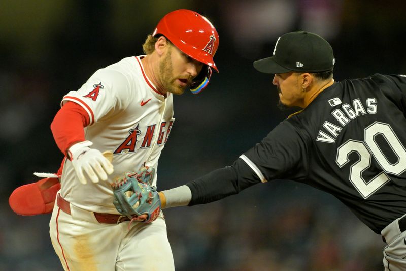 Sep 17, 2024; Anaheim, California, USA;  Los Angeles Angels left fielder Taylor Ward (3) is tagged out by Chicago White Sox third baseman Miguel Vargas (20) in the third inning at Angel Stadium. Mandatory Credit: Jayne Kamin-Oncea-Imagn Images