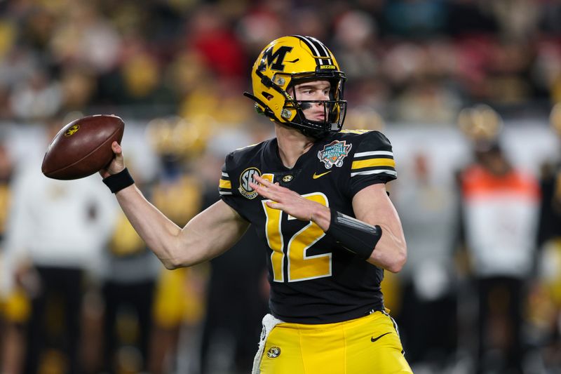 Dec 23, 2022; Tampa, Florida, USA;  Missouri Tigers quarterback Brady Cook (12) drops back to pass against the Wake Forest Demon Deacons in the first quarter in the 2022 Gasparilla Bowl at Raymond James Stadium. Mandatory Credit: Nathan Ray Seebeck-USA TODAY Sports