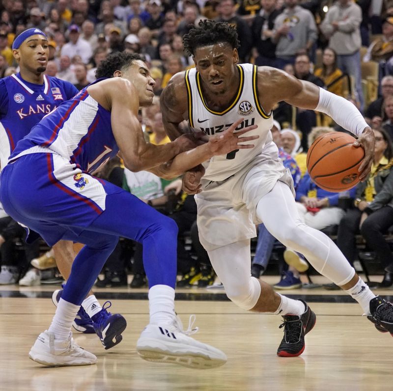 Dec 10, 2022; Columbia, Missouri, USA; Missouri Tigers guard DeAndre Gholston (4) dribbles the ball as Kansas Jayhawks guard Kevin McCullar Jr. (15) defends during the first half at Mizzou Arena. Mandatory Credit: Denny Medley-USA TODAY Sports