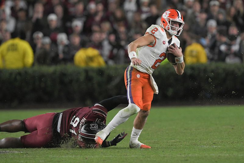 Nov 25, 2023; Columbia, South Carolina, USA; Clemson Tigers quarterback Cade Klubnik (2) runs against South Carolina defensive tackle Tonka Hemingway (91) during the fourth quarter at Williams-Brice Stadium.  Clemson won 16-7. Mandatory Credit: Ken Ruinard-USA TODAY Sports