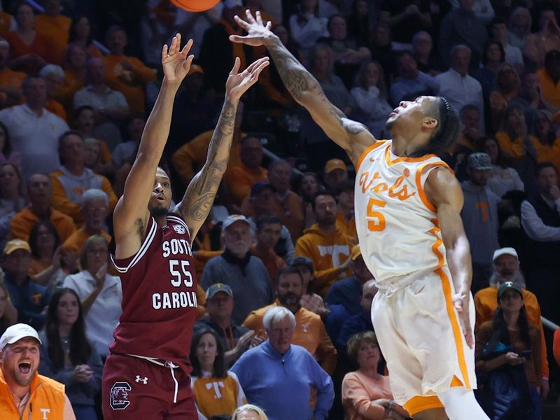 Jan 30, 2024; Knoxville, Tennessee, USA; South Carolina Gamecocks guard Ta'Lon Cooper (55) shoots a three pointer against Tennessee Volunteers guard Zakai Zeigler (5) during the second half at Thompson-Boling Arena at Food City Center. Mandatory Credit: Randy Sartin-USA TODAY Sports