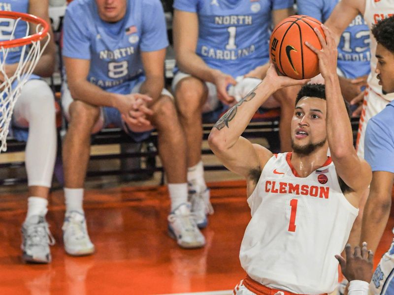 Jan 6, 2024; Clemson, South Carolina, USA; Clemson senior guard Chase Hunter (1) shoots near University of North Carolina forward Jae'Lyn Withers (24) during the first half at Littlejohn Coliseum. Mandatory Credit: Ken Ruinard-USA TODAY Sports