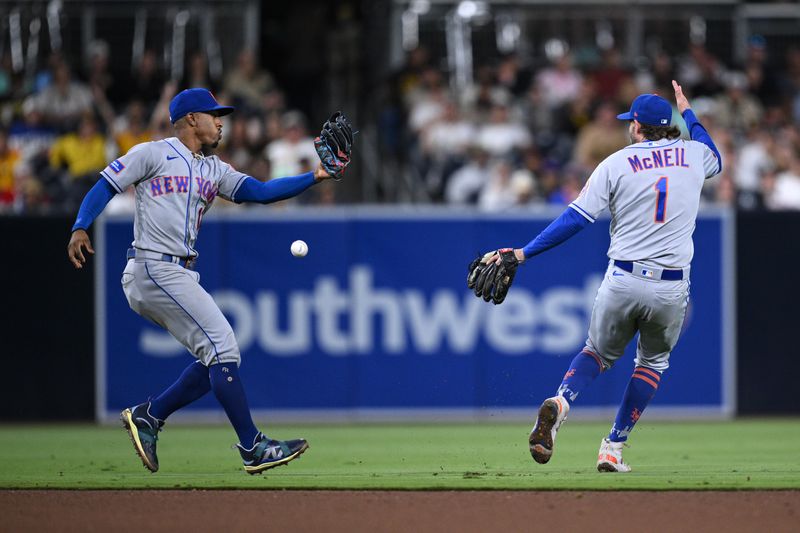 Jul 8, 2023; San Diego, California, USA; New York Mets shortstop Francisco Lindor (left) cannot make a catch on a ball hit by San Diego Padres shortstop Xander Bogaerts (not pictured) during the eighth inning at Petco Park. Lindor  was charged with an error on the play. Mandatory Credit: Orlando Ramirez-USA TODAY Sports