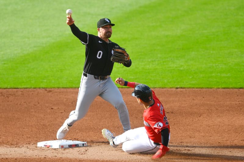 Jul 3, 2024; Cleveland, Ohio, USA; Chicago White Sox second baseman Danny Mendick (0) throws to first base after a force out of Cleveland Guardians left fielder Steven Kwan (38) in the first inning at Progressive Field. Mandatory Credit: David Richard-USA TODAY Sports