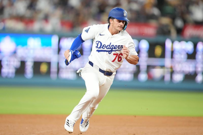 Aug 8, 2025; Los Angeles, California, USA; Los Angeles Dodgers second baseman Alex Freeland (76) runs to third base against the Toronto Blue Jays at Dodger Stadium. Mandatory Credit: Kirby Lee-Imagn Images