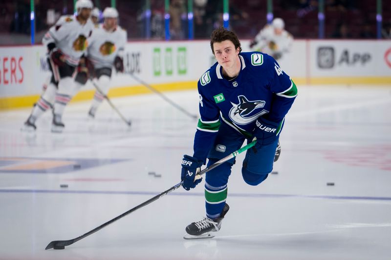 Apr 6, 2023; Vancouver, British Columbia, CAN; Vancouver Canucks defenseman Cole McWard (48) handles the puck in warm up prior to his first NHL appearance before a game against the Chicago Blackhawks at Rogers Arena. Mandatory Credit: Bob Frid-USA TODAY Sports