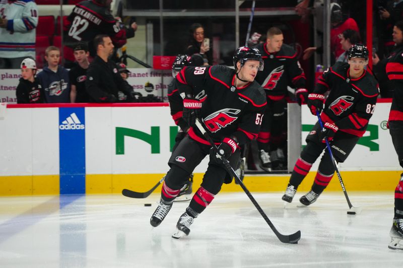 Mar 12, 2024; Raleigh, North Carolina, USA; Carolina Hurricanes left wing Jake Guentzel (59) comes out onto the ice for the warmups before the game against the New York Rangers at PNC Arena. Mandatory Credit: James Guillory-USA TODAY Sports