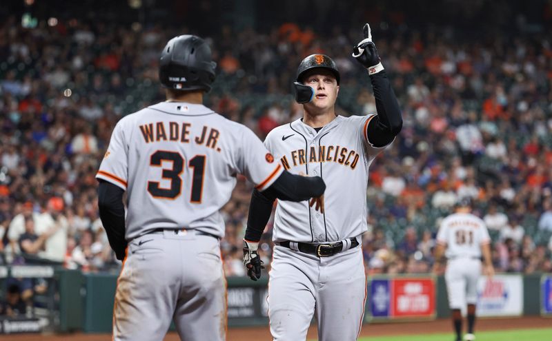 May 1, 2023; Houston, Texas, USA; San Francisco Giants designated hitter Joc Pederson (23) celebrates with first baseman LaMonte Wade Jr. (31) after hitting a home run during the third inning against the Houston Astros at Minute Maid Park. Mandatory Credit: Troy Taormina-USA TODAY Sports