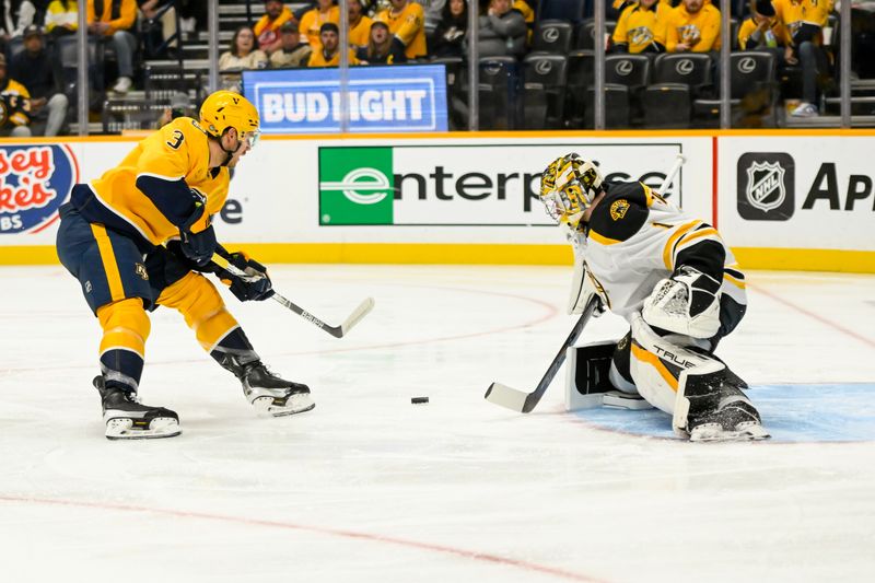 Oct 22, 2024; Nashville, Tennessee, USA;  Boston Bruins goaltender Jeremy Swayman (1) blocks the shot of Nashville Predators defenseman Jeremy Lauzon (3) during the first period at Bridgestone Arena. Mandatory Credit: Steve Roberts-Imagn Images