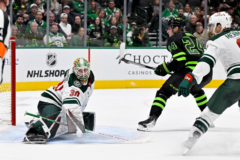 Jan 10, 2024; Dallas, Texas, USA; Dallas Stars center Roope Hintz (24) scores a goal against Minnesota Wild goaltender Jesper Wallstedt (30) during the second period at the American Airlines Center. Mandatory Credit: Jerome Miron-USA TODAY Sports