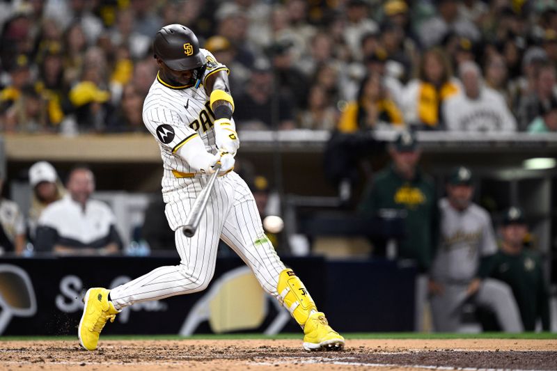 Jun 11, 2024; San Diego, California, USA; San Diego Padres left fielder Jurickson Profar (10) hits a two-RBI single against the Oakland Athletics during the fifth inning at Petco Park. Mandatory Credit: Orlando Ramirez-USA TODAY Sports