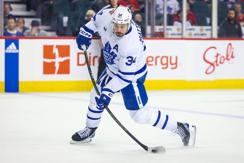 Jan 18, 2024; Calgary, Alberta, CAN; Toronto Maple Leafs center Auston Matthews (34) shoots the puck against the Calgary Flames during the third period at Scotiabank Saddledome. Mandatory Credit: Sergei Belski-USA TODAY Sports