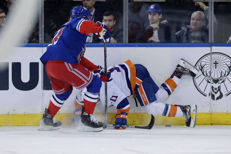 Nov 8, 2022; New York, New York, USA; New York Rangers center Barclay Goodrow (21) trips New York Islanders left wing Zach Parise (11) during the second period at Madison Square Garden. Mandatory Credit: Jessica Alcheh-USA TODAY Sports